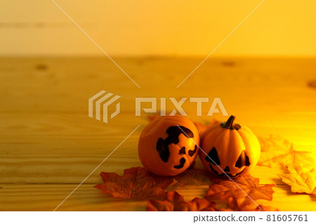 Halloween pumpkins with painted faces on a wooden table. Halloween background. Space for text. copy space. Halloween concept Halloween pumpkins with painted faces on a wooden table. Halloween background. Space for text. copy space. Halloween concept 81605761