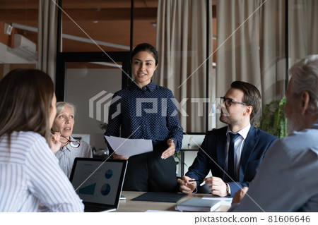 Smiling Indian businesswoman mentor executive speaking at corporate meeting Smiling Indian businesswoman mentor executive speaking at corporate meeting 81606646