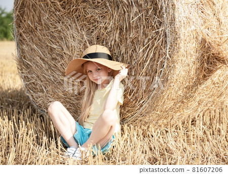 Little girl having fun in a wheat field on a summer day. 81607206