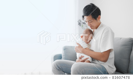 A father holding a baby A father holding a baby 81607478