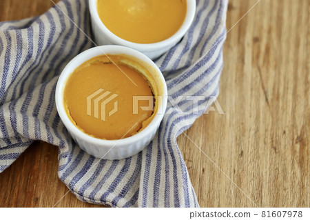 Baked pumpkin pudding made in a cocotte and linen cloth 81607978