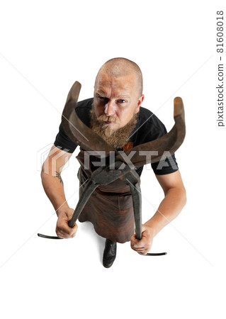 High angle view of bearded bald man, blacksmith wearing leather apron or uniform isolated on white studio background. Concept of labor, retro professions, power, beauty, humor High angle view of bearded bald man, blacksmith wearing leather apron or uniform isolated on white studio background. Concept of labor, retro professions, power, beauty, humor 81608018