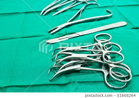 Surgical instruments on the green fabric in the operating room 81608264