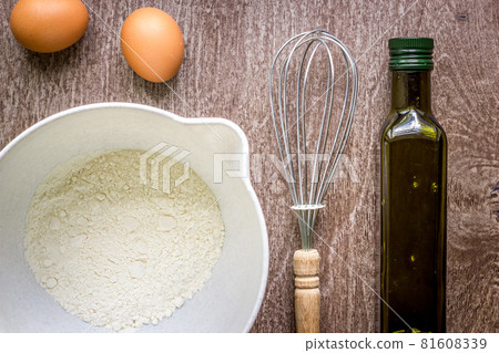 Food ingredients and kitchen utensils for cooking on wooden background 81608339