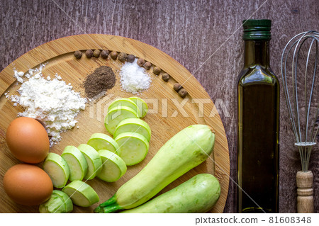 Healthy eating, vegetarian food. Raw zucchini prepared for frying in a frying pan with spices in olive oil Healthy eating, vegetarian food. Raw zucchini prepared for frying in a frying pan with spices in olive oil 81608348