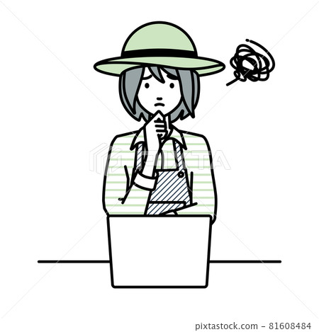 A farmer woman sitting at a desk and opening her PC 81608484