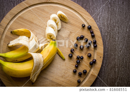 Currants and fresh banana on wooden table. Currants and fresh banana on wooden table. 81608551