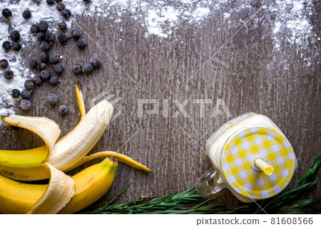 Banana smoothie and fresh banana on wooden table. Banana smoothie and fresh banana on wooden table. 81608566