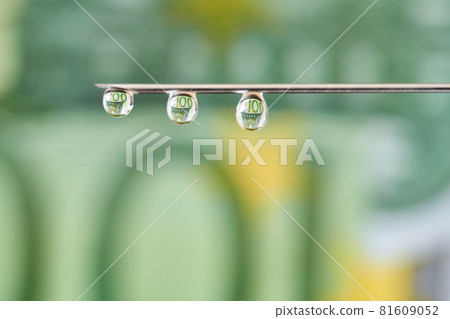 On the needle of the euro. Drops flows from the syringe needle with the reflection of euro. Concept of investment, the cost of drugs and treatment, drug addiction, corruption. 81609052