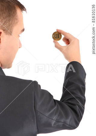 Man holding golden Bitcoin isolated on white Man holding golden Bitcoin isolated on white 81610136