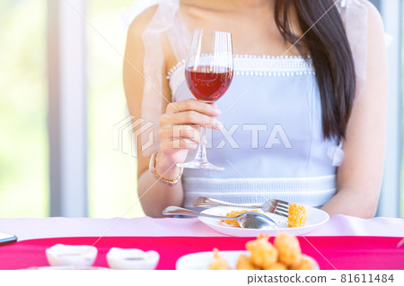 Valentine's day concept, Asian young girl sitting at a table food with wine glasses and bouquet of red and pink roses wine and waiting for her man at in the restaurant background Valentine's day concept, Asian young girl sitting at a table food with wine glasses and bouquet of red and pink roses wine and waiting for her man at in the restaurant background 81611484