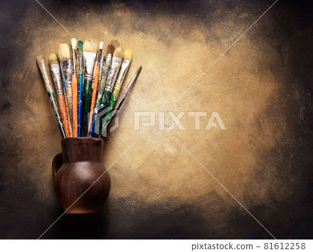 Paint brush in clay jug at art painting canvas as abstract background texture. Paintbrush painting Paint brush in clay jug at art painting canvas as abstract background texture. Paintbrush painting 81612258