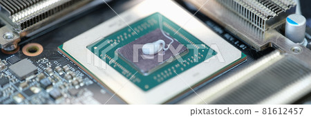 Thermal paste lying on microchip for video card closeup Thermal paste lying on microchip for video card closeup 81612457
