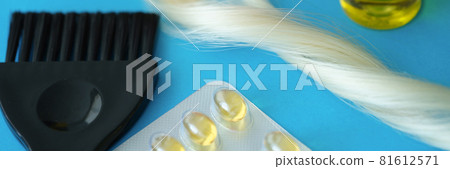 Vitamins and hair oil together with brush lie on dove background Vitamins and hair oil together with brush lie on dove background 81612571