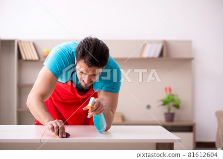 Young male contractor cleaning the house Young male contractor cleaning the house 81612604
