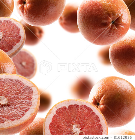 Whole and cut grapefruits levitate on a white background 81612956