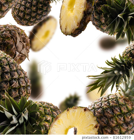Ripe pineapples levitate on a white background Ripe pineapples levitate on a white background 81612959