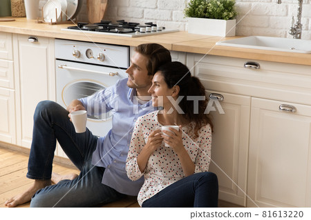 Dreamy millennial couple enjoying peaceful weekend at home. 81613220