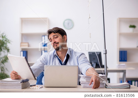 Young male employee suffering at workplace Young male employee suffering at workplace 81613506
