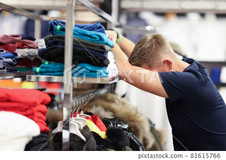 Tired man leaned on shelf with things in store Tired man leaned on shelf with things in store 81615766