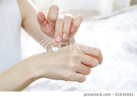 Woman's hand applying cream Woman's hand applying cream 81616892