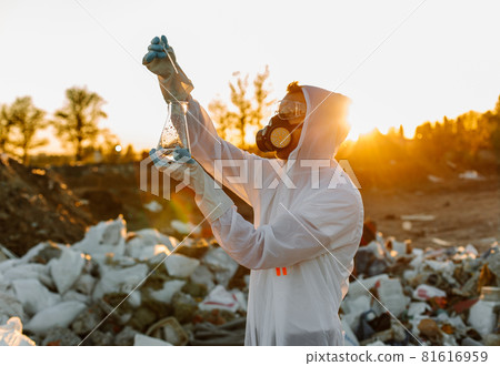 Close-up scientist examining sampling of toxic chemicals on polluted ground Close-up scientist examining sampling of toxic chemicals on polluted ground 81616959