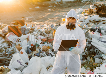 Researcher looking at plastic landfill analyzing environmental pollution level 81616962