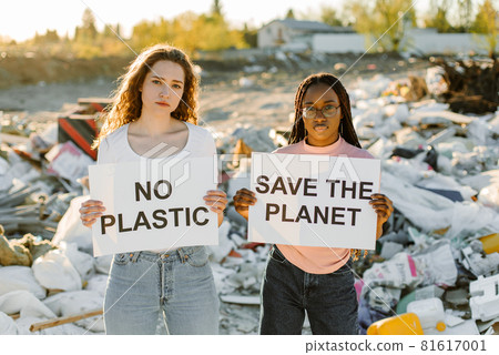Ecology activists holding signs agains pollution at trash pill Ecology activists holding signs agains pollution at trash pill 81617001