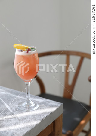 Pink Cocktail glass with ice at gray table 81617261