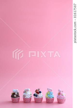 Colorful cupcakes isolated in pink background Colorful cupcakes isolated in pink background 81617587