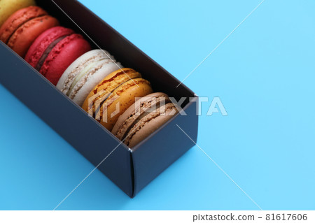Colorful macarons isolated in blue background Colorful macarons isolated in blue background 81617606
