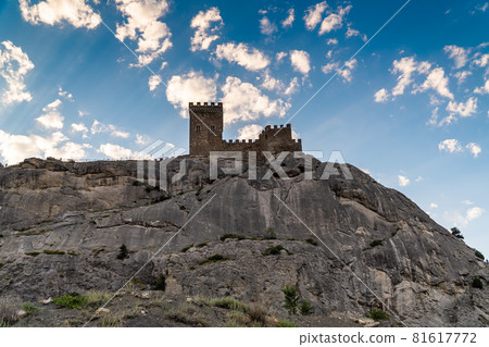 The Republic of Crimea. The city of Sudak. July 20, 2021. View of the walls and towers of the ancient Genoese fortress, located on the fortress hill, from the city embankment. The Republic of Crimea. The city of Sudak. July 20, 2021. View of the walls and towers of the ancient Genoese fortress, located on the fortress hill, from the city embankment. 81617772