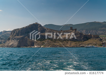 The Republic of Crimea. the city of Sudak. July 20, 2021. View of the ancient Genoese fortress from the Black Sea from the Sudak Bay. The Republic of Crimea. the city of Sudak. July 20, 2021. View of the ancient Genoese fortress from the Black Sea from the Sudak Bay. 81617774
