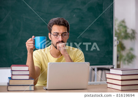 Young male student preparing for exams in the classroom 81619694