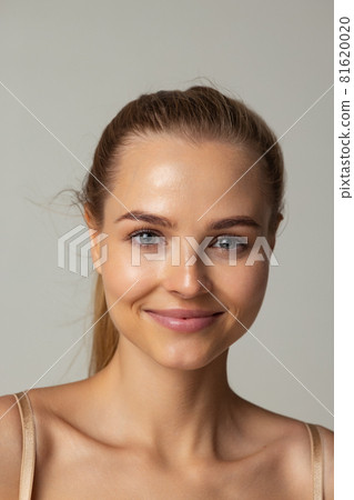 Close-up side view portrait of young beautiful woman in bun isolated over pastel studio background Close-up side view portrait of young beautiful woman in bun isolated over pastel studio background 81620020