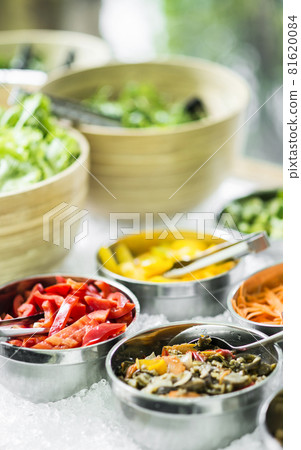 bowls of mixed fresh organic vegetables in salad bar display 81620084