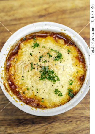 traditional british cottage pie bowl meal on rustic wood table 81620146