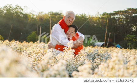 Asian elder couple celebrating christmas and New Year in flower garden forever happy love Asian elder couple celebrating christmas and New Year in flower garden forever happy love 81620176