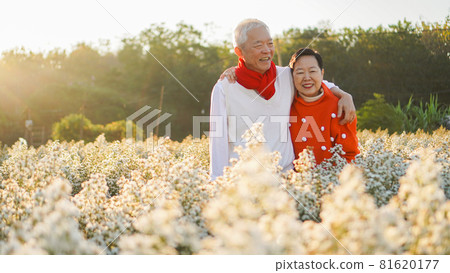 Asian elder couple celebrating christmas and New Year in flower garden forever happy love Asian elder couple celebrating christmas and New Year in flower garden forever happy love 81620177