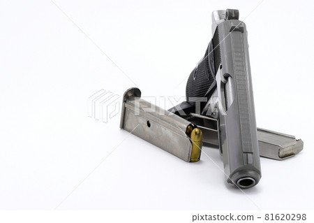 The compact Semi automatic pistol, stainless steel PPKs pistol with spare magazines right side view, Ready for use, lying isolated on white background. The compact Semi automatic pistol, stainless steel PPKs pistol with spare magazines right side view, Ready for use, lying isolated on white background. 81620298