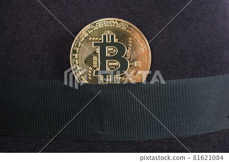 Bitcoin in a felt men's hat isolated on white Bitcoin in a felt men's hat isolated on white 81621084