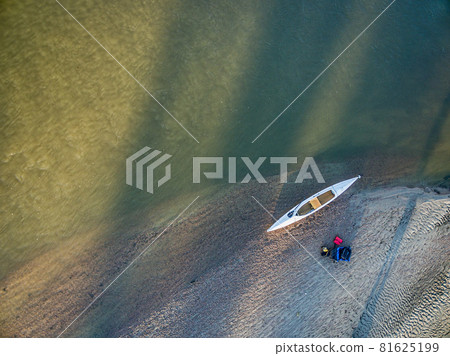 aerial view of canoe on river shore 81625199