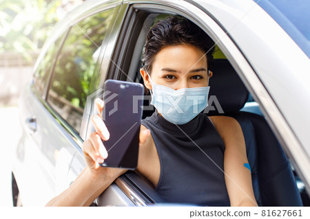 Closeup shot of blank screen mobile phone for application appointment registration copy space in female hand wearing face mask sitting in car in drive through line for coronavirus vaccination Closeup shot of blank screen mobile phone for application appointment registration copy space in female hand wearing face mask sitting in car in drive through line for coronavirus vaccination 81627661