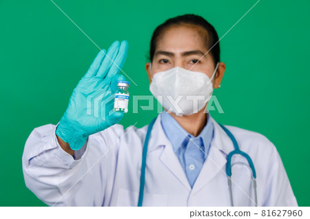 Focusing on asian female doctor wearing lab coat hand holding syringe and Covid 19 vaccine vial bottle. Concept for Covid 19 vaccination 81627960