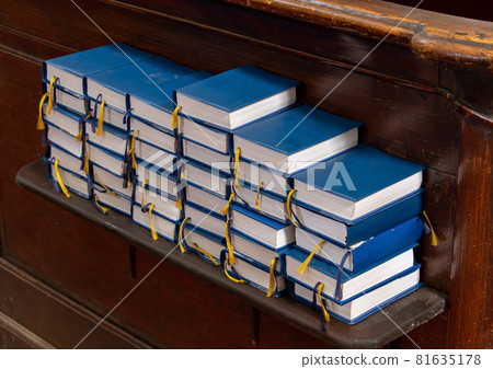 A stacks of books for prayer and religious sing on the shelf in the church A stacks of books for prayer and religious sing on the shelf in the church 81635178