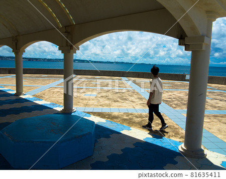 A boy walking along the coastal street A boy walking along the coastal street 81635411