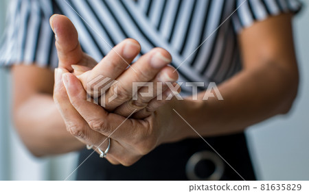 Woman shows hand and hold palm.with feeling pain, suffer, hurt and tingling. Concept of Guillain barre syndrome and numb hands disease effect Woman shows hand and hold palm.with feeling pain, suffer, hurt and tingling. Concept of Guillain barre syndrome and numb hands disease effect 81635829
