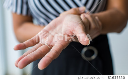 Woman shows hand and hold wrist with feeling pain, suffer, hurt and tingling. Concept of Guillain barre syndrome and numb hands disease effect Woman shows hand and hold wrist with feeling pain, suffer, hurt and tingling. Concept of Guillain barre syndrome and numb hands disease effect 81635830