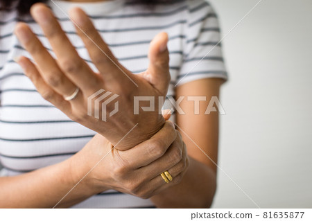 Woman in using hand to hold wrist and stretching fingers. with feeling pain, suffer, hurt and tingling. Concept of Guillain barre syndrome and numb hands disease Woman in using hand to hold wrist and stretching fingers. with feeling pain, suffer, hurt and tingling. Concept of Guillain barre syndrome and numb hands disease 81635877