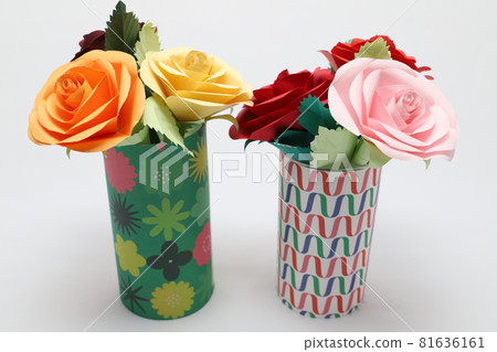 Handmade rose flowers made from origami are displayed in a beautiful vase 81636161